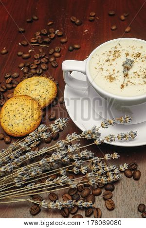 Cup of coffee with milk pussy-willow and dried branches and leaves at white background. Cake on desk