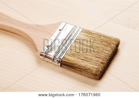 Hand painting grey color on wooden table use for home decorated. House renovation. Half - painted surface. Smear of paint brush