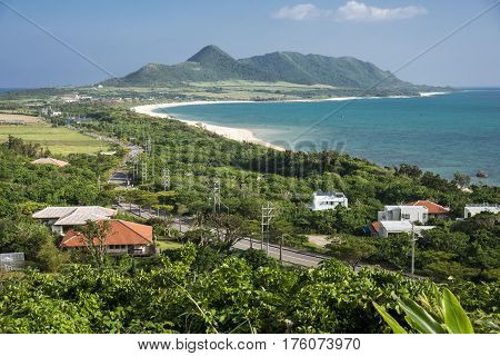 Forest through road beside sea in front of hirakubo peninsula in Ishigaki island