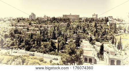 View from top of ancient walls surrounding Old City in Jerusalem. View on the landmarks of Jerusalem Old City. Vintage Style Toned Picture