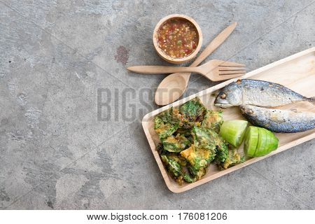 Thai local popular food as spicy shrimp paste dip (Nam Prik Kapi in Thai) served with fried mackerels sliced cucumber and fried acacia pennata omelet