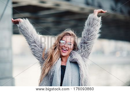 Close up shot stylish happy young woman with hands up