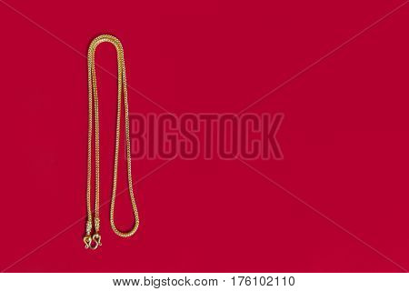 Gold Necklace 96.5 Percent Thai Gold Grade With Gold Hook Isolated On Red Background