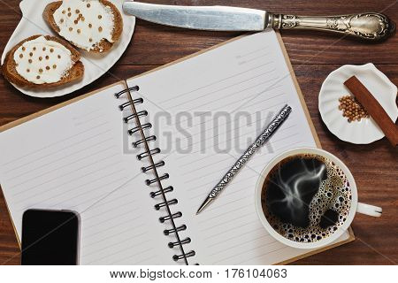 Planning the day while having coffee with brown bread sandwiches with spreading cheese and coriander