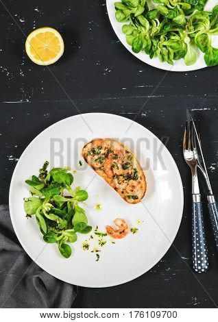Healthy sandwich with shrimps and green salad dressed with olive oil and lemon