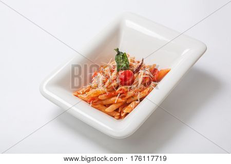 Penne Pasta With Tomato Sauce Sprinkled With Parmesan Cheese In A Deep White Plate