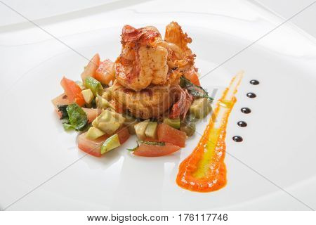 Fried Shrimps On Fried Vegetables On A White Plate