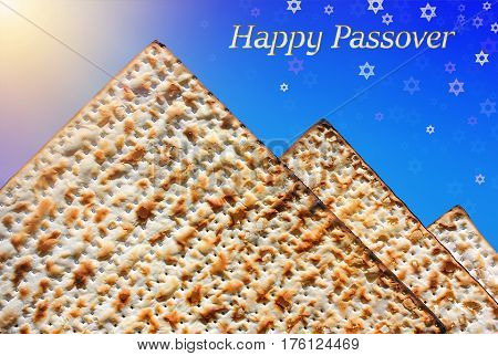 jewish holiday of Passover, stylized pyramid of matzo on the blue background with Stars of David and inscription - Happy Passover