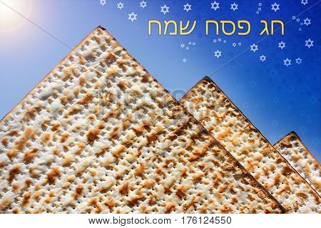 jewish holiday of Passover, stylized pyramid of matzo on the blue background with Stars of David and inscription  in hebrew - Happy Passover