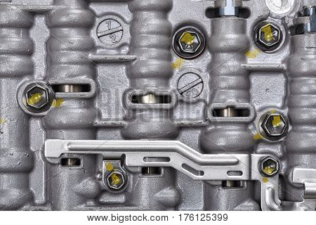Mechanical part with metal components and hydraulic valves. Car repair. Engineering. Tools and spares.