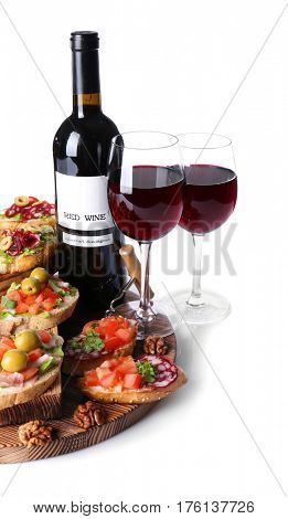 Tasty bruschetta served with wine on white background