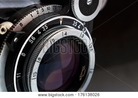 Retro camera lens close up on dark background