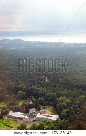 View from heights of Tallinn TV tower on glass pavilions greenhouses and outdoor gardens of the Botanical garden. Types and horizons of Baltic cities with altitude. Baltic States Estonia