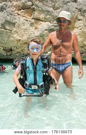Child Discover Scuba Diving At Cala Mariolu Beach On Sardinia