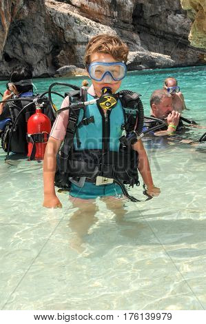 Child Discover Scuba Diving At Cala Mariolu Beach On Sardinia