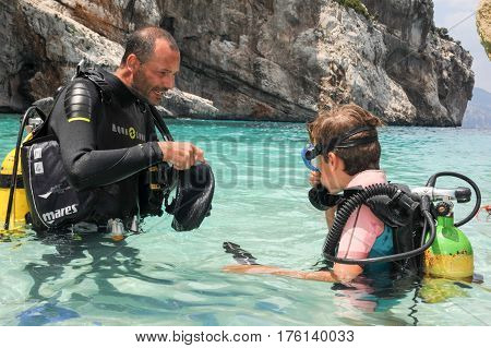 Child Discover Scuba Diving At Cala Mariolu Beach On Sardinia