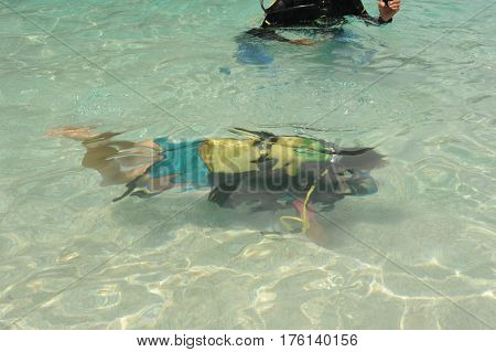 Cala Mariolu, Italy - 28 June 2013: Child discover scuba diving at Cala Mariolu beach on Sardinia, Italy