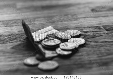 Pound sterling and coins quids nicker on oak table in luxury restaurant in London.