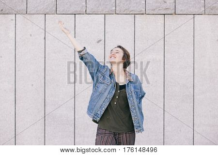 positive teen androgynous woman laughing with a cheerful attitude towards life