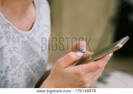 Beautiful girl holding a smartphone in the hands of a green screen green screen, hand of man holding mobile smart phone with chroma key green screen on white background, new technology concept