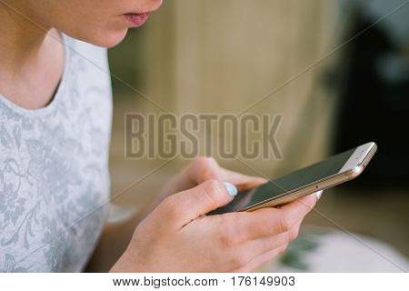 Beautiful girl holding a smartphone in the hands of a green screen green screen, hand of man holding mobile smart phone with chroma key green screen on white background, new technology concept