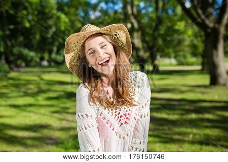 Young Beautiful Woman In Hat Laughing Outside