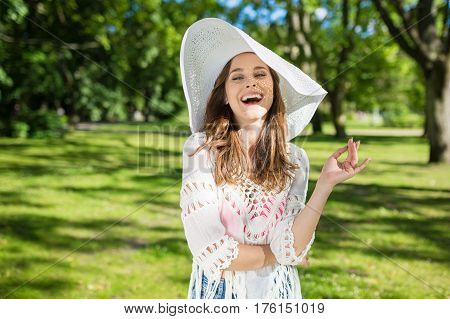 Beautiful Young Woman In Hat Laughing At Park
