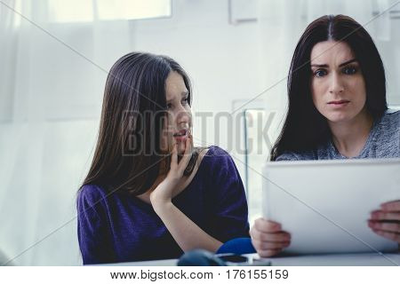 Scared mother arguing daughter over online activity. Cyber bullying or blue whale game concept