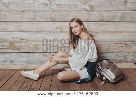 Fashion lifestyle portrait of young pretty woman sitting in wooden room. Processed with VSCO f3 preset