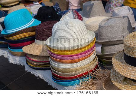 Varied fashion hats showcase on open market shop