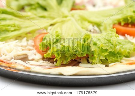 Preparing Pizza With Lettuce And Tomato Over White Background