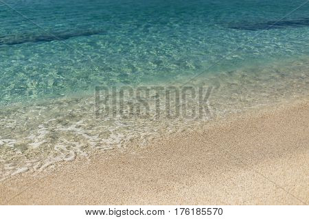 Beach sand and turquoise sea water of Kleopatra beach in Alanya shot on sunny day