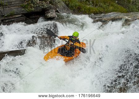 Kayaker in the waterfall in Norway Ula river
