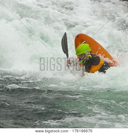 Kayaker in the waterfall in Norway Ula river