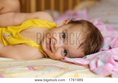 Baby Lying On Bed