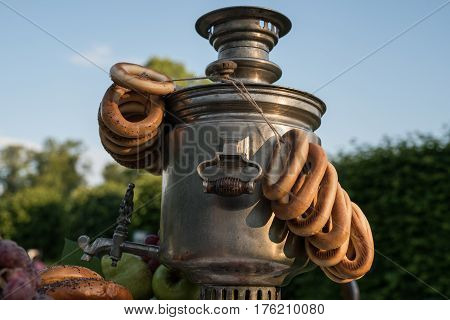 A Samovar With A Bunch Of Bagels Hanging On It