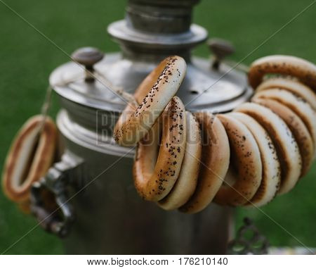 A Samovar With A Bunch Of Bagels Hanging On It