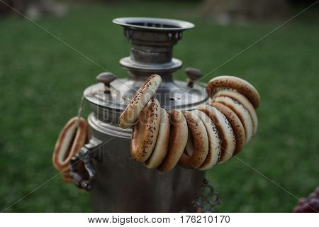 A Samovar With A Bunch Of Bagels Hanging On It