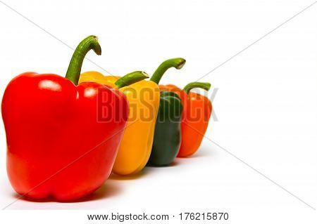Red green and orange sweet bell peppers isolated on white background