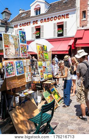 Paris France - June 30 2006: Artists exposing their works to the tourists in open air at Tertre square (Place du Tertre) in Montmartre.