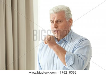Mature man with allergy at home