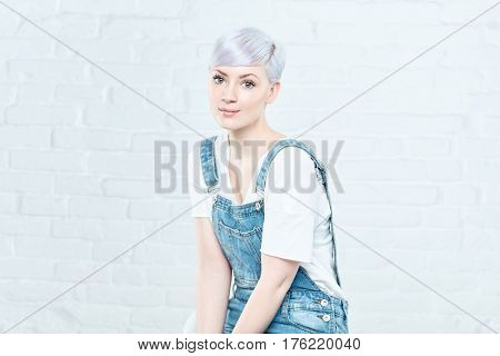 Young platinum blonde woman in twiggy-style, looking at camera.