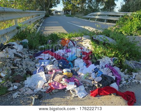 Alora Spain - March 11 2017: Large amount of clothes dumped on bridge approach