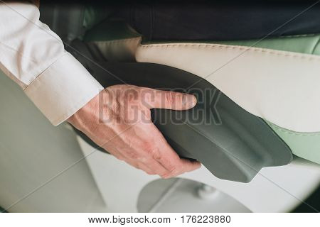 Hand On The Arm Of A Man Sitting In A Chair