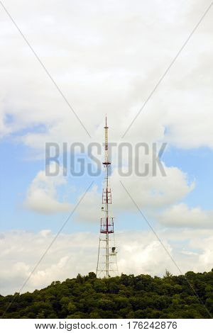 Digital television Tower against cloudy blue sky in distance