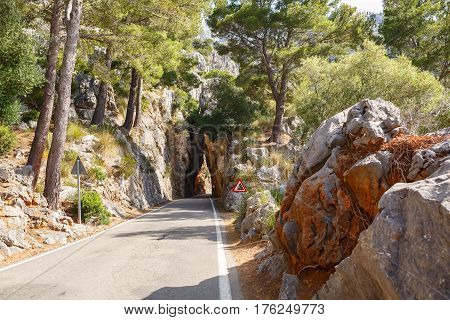 Mountain road road going into a stone tunnel near the village Sa Calobra. Island Majorca, Spain