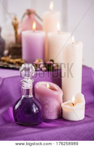Composition with bottles of aroma oil and aroma candles. Spa setting for relaxing aromatherapy