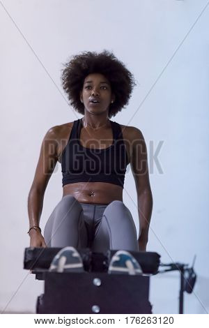 young fit african american woman doing sit ups in fitness studio at the gym.Abdominal exercises Sit up