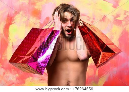 Caucasian Bearded Sexy Macho Man Holding Red Packages Or Bags