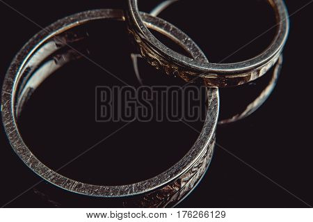 Hammered golden weddin rings. macro. sunsine sparkle